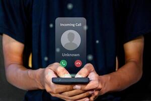 Man answering an incoming call from unknown number. Spammer incoming call concept. photo