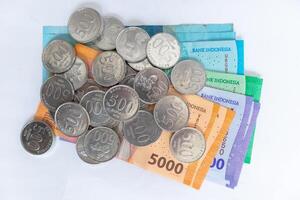 Top view of Indonesian Rupiah money and coins on a white background. Rupiah banknotes. photo