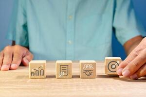 Business strategy or action plan concept. Increase revenue, market analysis, teamwork, and goal or target on wooden blocks. photo