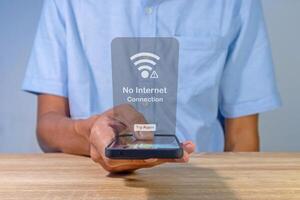 Man using a smartphone with no internet connection on screen. No internet access or bad connection concept. photo