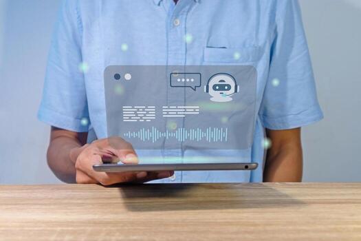 Man holding a smart tablet with virtual screen of artificial intelligence robot or chatbot technology concept. photo