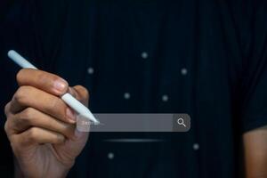 A man searching for information using internet on virtual screen. Search engine optimization concept. photo