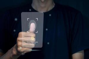 A man unlocks a smart phone by scanning fingerprint on virtual screen. Security access with biometric identification concept. photo