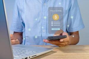 A man using a smartphone to access online mobile banking. Concept of money transfer or payment transaction. photo