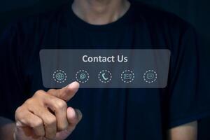 A man touching on virtual screen contact icons. Contact us, call center, hotline operator or customer support hotline on virtual screen. photo