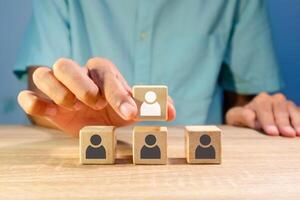 A man arranges the hierarchy of a company's business organization. Business organization hierarchy concept. photo