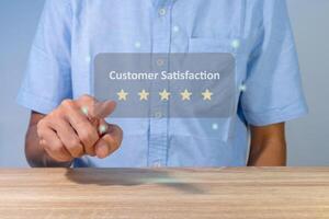 A man gives rating to service experience on online application. Customer review satisfaction feedback concept. photo