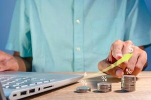 Man working with laptop to analyze business financial data report. Graph of increasing profit, revenue, price, sales, or interest. photo