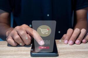 A man uses a smart phone for online shopping. A smart phone with virtual screen of ecommerce store page. photo