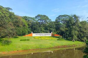 Depok, Indonesia, 2024 - View of signboard of University of Indonesia and trees in background photo