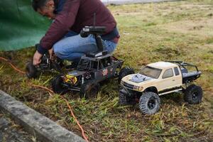 Two toy racing trucks are preparing for their competition. photo