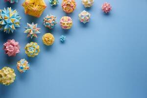 Set of multicolor handmade modular origami balls or Kusudama Isolated on blue background. Visual art, geometry, art of paper folding, paper crafts. photo