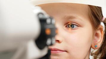 Eye iris and pupil macro. Reflected moving light rays into the child eye with zoom. Close up. The concept of ophthalmology and medicine. Medical attendance at the optometrist in a bright modern clinic photo