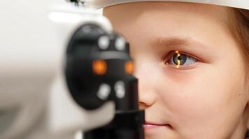 Eye iris and pupil macro. Reflected moving light rays into the child eye with zoom. Close up. The concept of ophthalmology and medicine. Medical attendance at the optometrist in a bright modern clinic photo