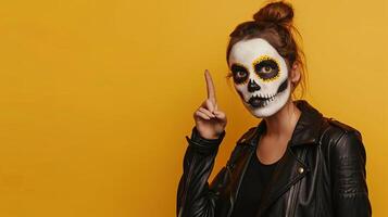 Close-up shot of a female with white clay skull makeup, wearing black clothes, pointing away into blank space, set against a vivid yellow background, spooky Halloween theme, photorealistic photo