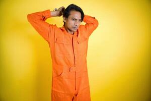 Contemplative prisoner man in jumpsuit photo