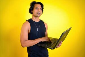 Man thinking while holding a laptop photo
