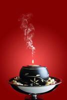 Candle light on red background photo
