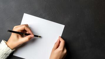 Top view of person writing by left hand photo