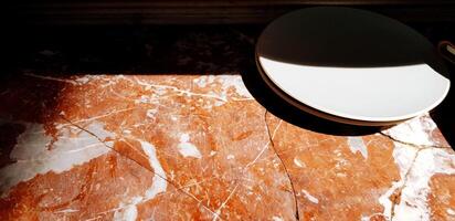 Gray or white plate putting on the marble table with sunlight and shadow with copy space. Art, Single object, Abstract background and Textured of surface photo