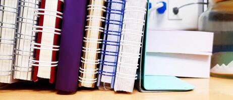 Close up many book is placed or putting on a wooden table at office or school. Education, Office tool and object concept. photo