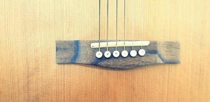 Close up guitar string on wooden background with copy space in vintage color tone. Art wallpaper, Surface, Pattern, Line, Instrument and Object concept. photo