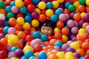 Happy children playing and having fun at kindergarten with colorful balls photo