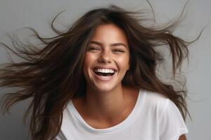 Portrait of young happy brunette with long fuzz hair woman with toothy smile laughing isolated over gray background. Generated AI. photo