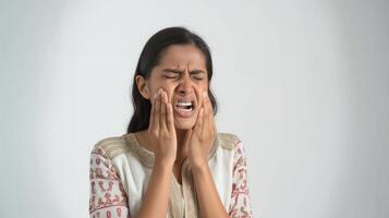 Am Indian woman suffering from toothache on a white background photo