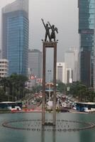 Modern cityscape with unique sculpture and fountain photo