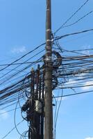 Tangled Wires Against Blue Sky photo