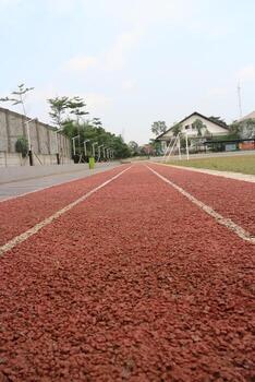 Close-up of Red Running Track with Lane Markings photo