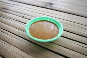 Peanut sauce in Bowl on Bamboo table photo