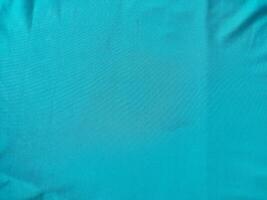 Cyan colored fabric texture and background photo