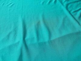 Cyan colored fabric texture and background photo