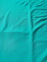 Cyan colored fabric texture and background photo