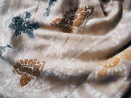 Fragments of colorful textile patterns with floral ornaments are useful as a background photo