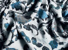 The fabric is patterned with a dense arrangement of blooming floral motifs in medium tones photo