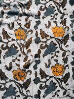 The fabric is patterned with a dense arrangement of blooming floral motifs in medium tones photo