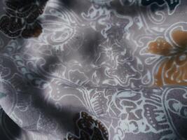 Fragments of colorful textile patterns with floral ornaments are useful as a background photo