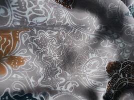 Fragments of colorful textile patterns with floral ornaments are useful as a background photo