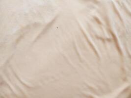 texture and background of wrinkled cream fabric photo