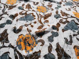 The fabric is patterned with a dense arrangement of blooming floral motifs in medium tones photo