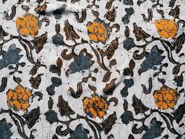 The fabric is patterned with a dense arrangement of blooming floral motifs in medium tones photo