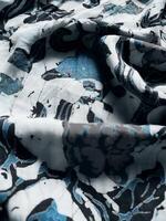 The fabric is patterned with a dense arrangement of blooming floral motifs in medium tones photo