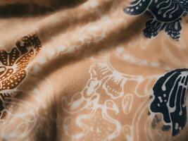 Fragments of colorful textile patterns with floral ornaments are useful as a background photo