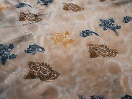Fragments of colorful textile patterns with floral ornaments are useful as a background photo
