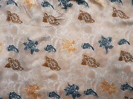 Fragments of colorful textile patterns with floral ornaments are useful as a background photo