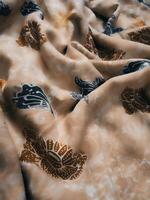 Fragments of colorful textile patterns with floral ornaments are useful as a background photo