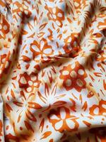The fabric is patterned with a dense arrangement of blooming floral motifs in medium tones photo